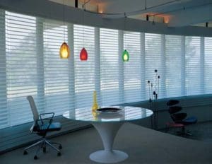 Modern living room with sleek white window blinds by Hunter Douglas