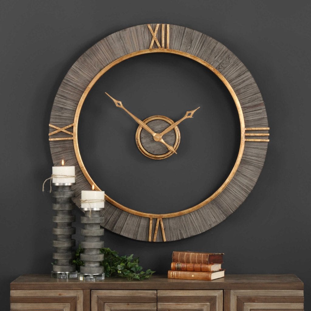 Wall clock features charcoal stained fir wood with antiqued gold accents and floating center dial. Quartz movement ensures accurate timekeeping. Requires one "AA" battery. 39" Round