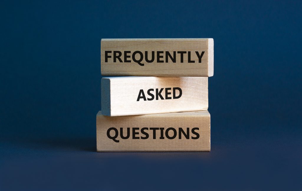 FAQ frequently asked questions symbol. Concept words FAQ frequently asked questions on blocks on beautiful grey table grey background. Business and FAQ frequently asked questions concept.