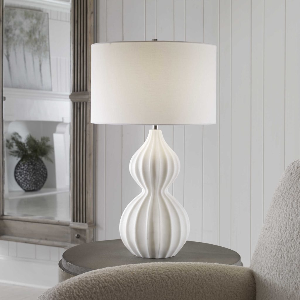 Table lamp in a rich ivory man-made stone with linen lamp shade REG $417 NOW $210